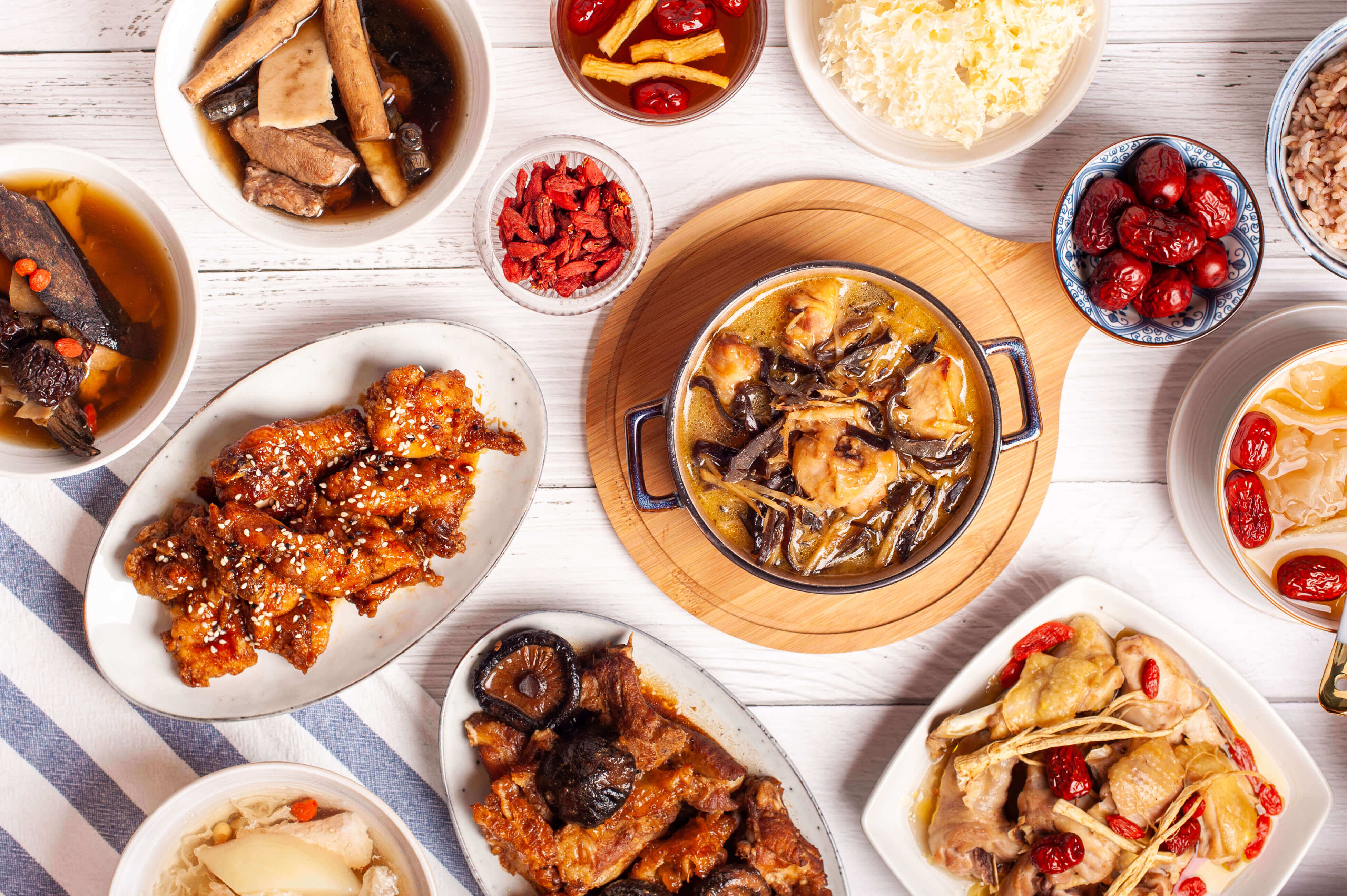 overhead view of a full Phoenix confinement meal set — herbal soups, main dishes, vegetables, rice and tong sui