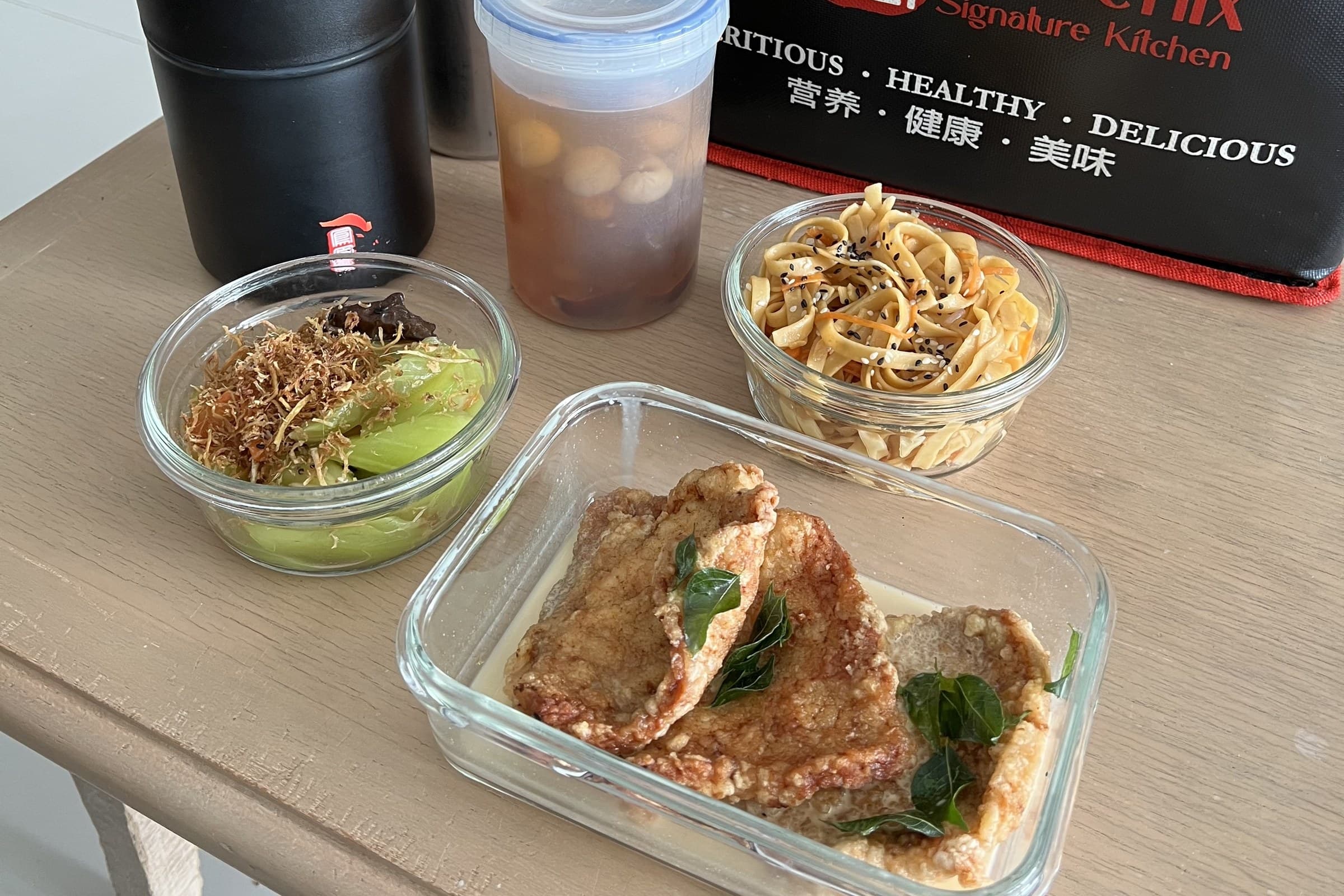 A Phoenix delivery: insulated bag, vacuum flasks, a drink and glass containers of food