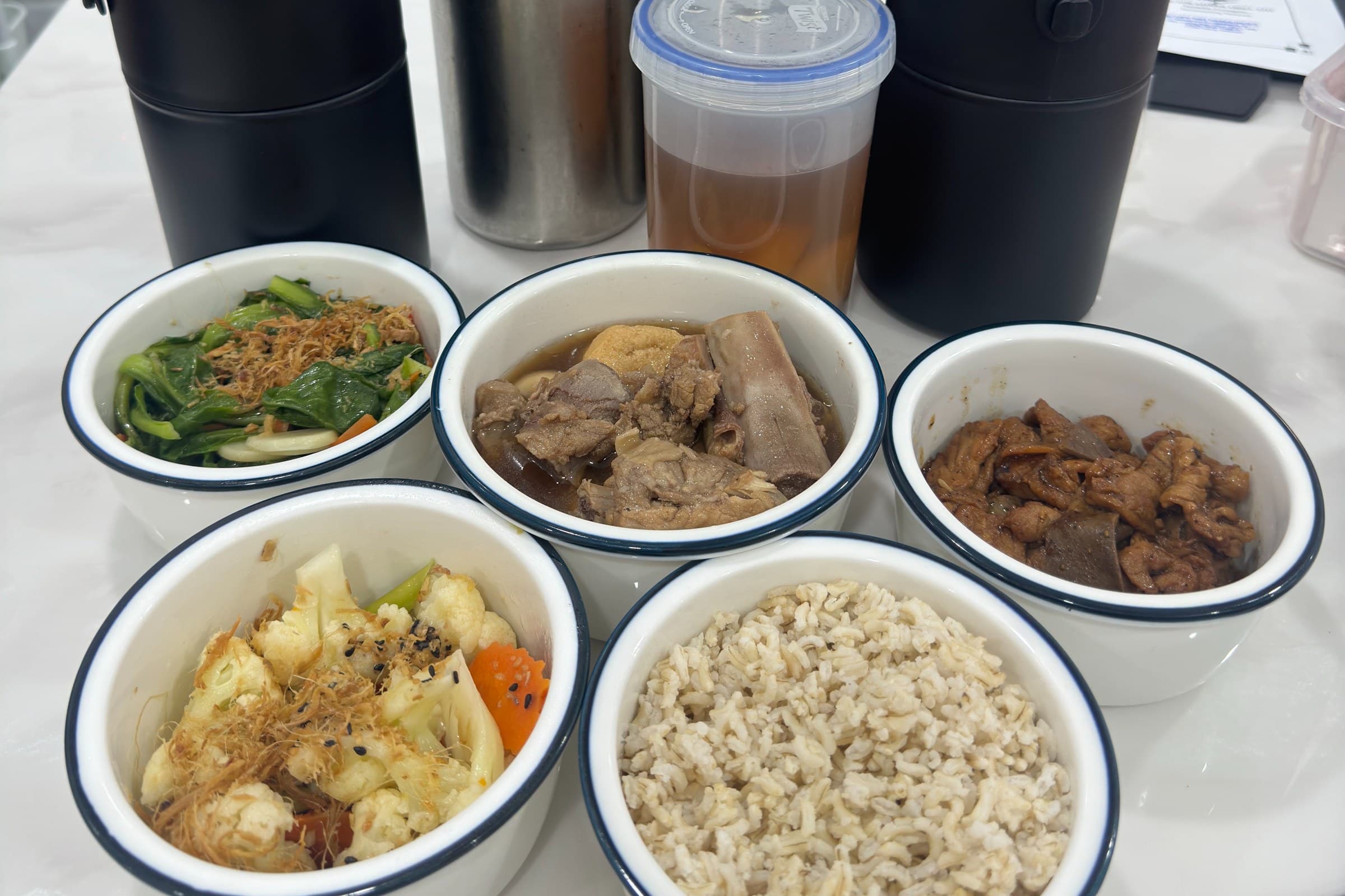 Five dishes with rice, soup and tea, in their ceramic bowls